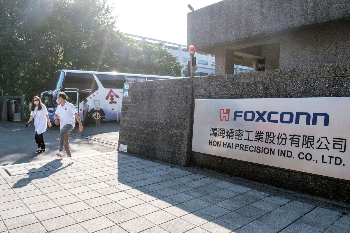 Signage at the Hon Hai Precision Industry Co. headquarters in New Taipei City, Taiwan, on Wednesday, Aug. 10, 2022. Taiwan wants to force Foxconn Technology Group to unwind an $800 million investment in Chinese chipmaker Tsinghua Unigroup, the Financial Times reported, citing unidentified people familiar with the matter. 