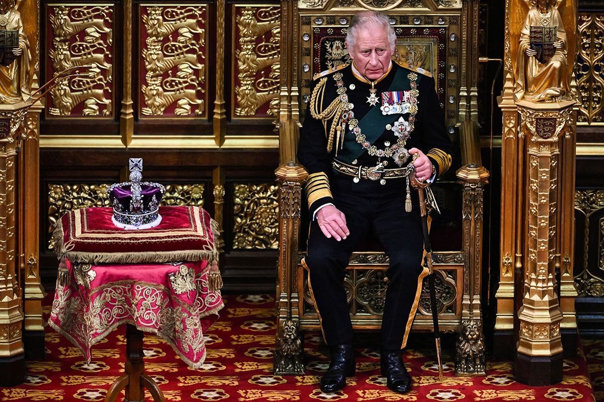 Britain's Prince Charles, Prince of Wales (R) sits by the The Imperial State Crown (L) in the House of Lords Chamber, during the State Opening of Parliament, in the Houses of Parliament, in London, on May 10, 2022. - The 96-year-old monarch, who usually presides over the pomp-filled event and reads out her government's legislative programme from a gilded throne in the House of Lords, will skip the annual showpiece on her doctors' advice. (Photo by Ben Stansall / POOL / AFP)