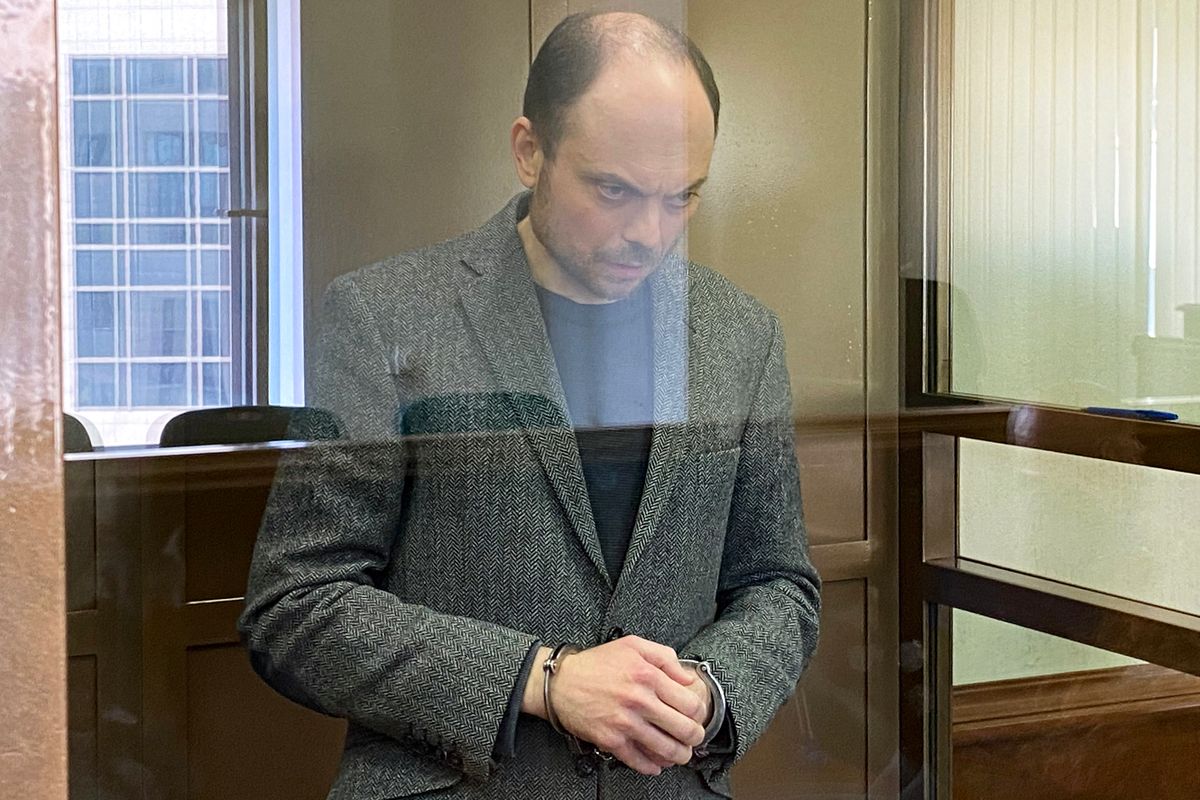 Russian opposition figure Vladimir Kara-Murza, who is accused of treason and spreading "false" information about the Russian army, stands inside a defendants' cage during his sentencing at the Moscow City Court in Moscow on April 17, 2023. 