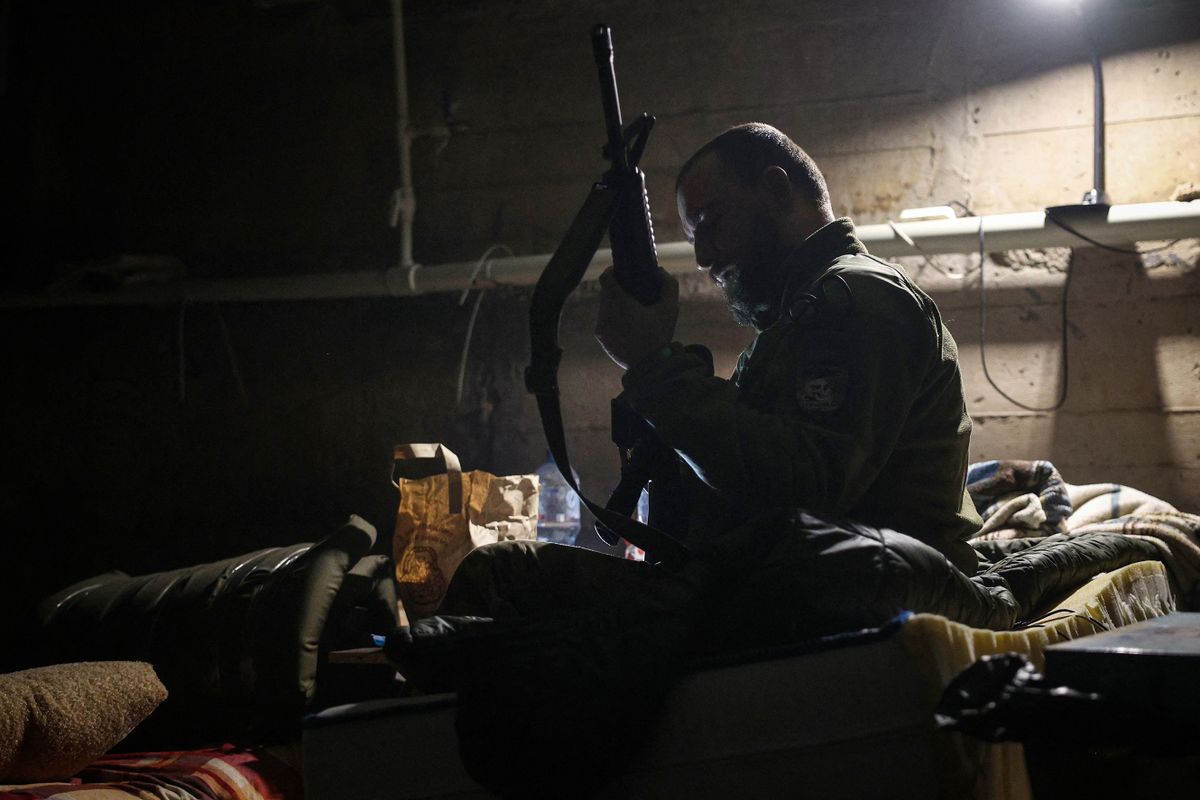 EDITORS NOTE: Graphic content / A Ukrainian serviceman checks his rifle in a bomb shelter in the frontline city of Bakhmut, Donetsk region on April 23, 2023, amid the Russian invasion of Ukraine. 