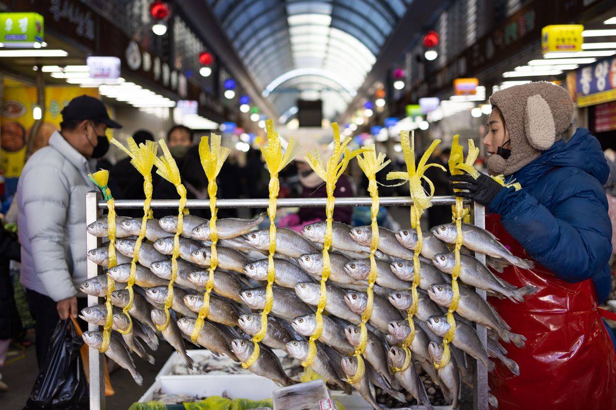 Dried yellow corvinas hang at a stall in Jeonju New Joongang Market ahead of Lunar New Year in Jeonju, Jeollabuk Province, South Korea, on Saturday, Jan. 21, 2023. South Korean policymakers should consider the impact on the economy and financial stability of their efforts to rein in inflation, according to central bank Governor Rhee Chang-yong, signaling a recalibration as a tightening cycle winds down. 