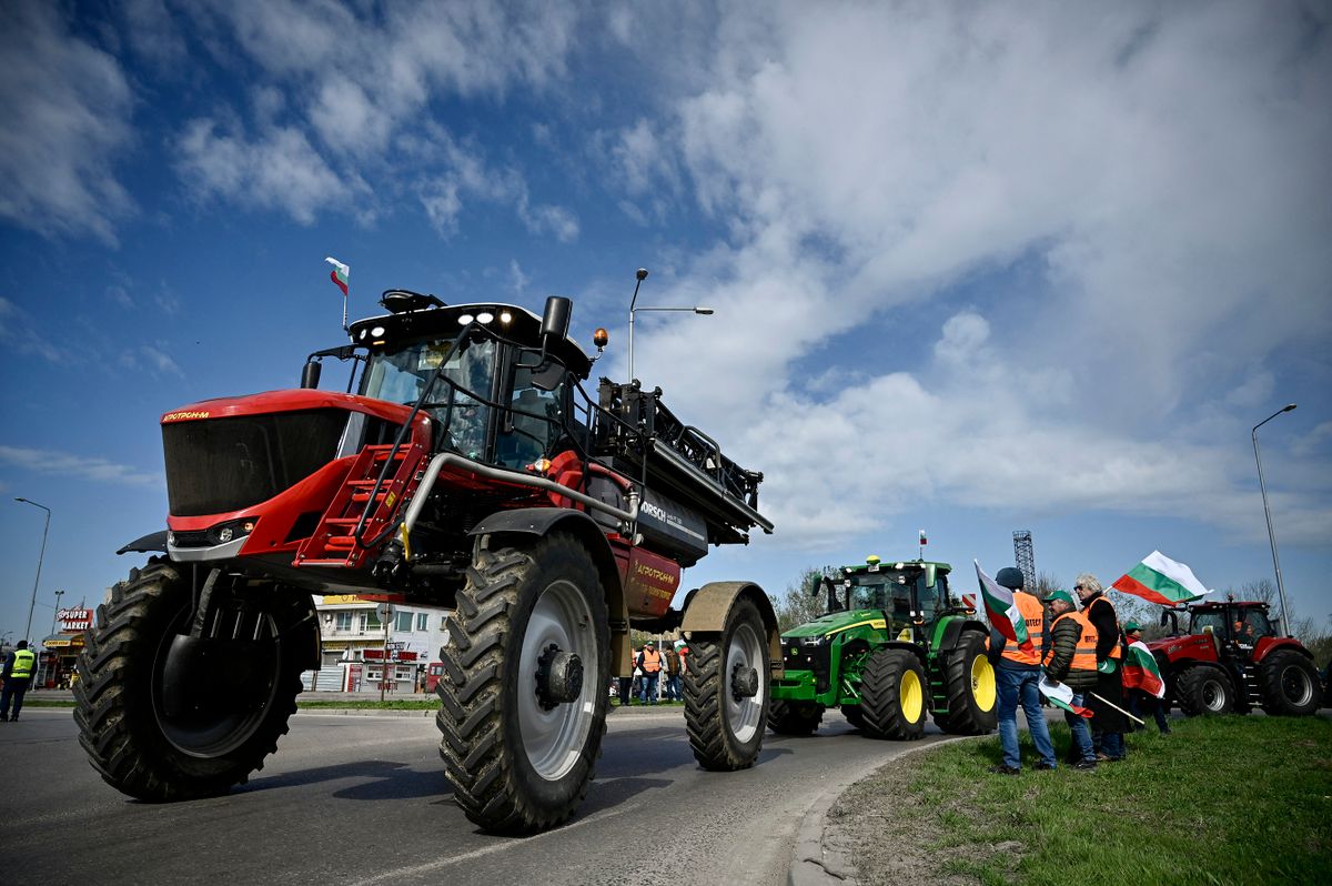 Farmers drive their tractors during an action to block trucks crossing the Danube bridge, marking the border between Bulgaria and Romania in a protest against the duty-free import of grain coming from Ukraine into the EU, in Rousse on March 29, 2023. 