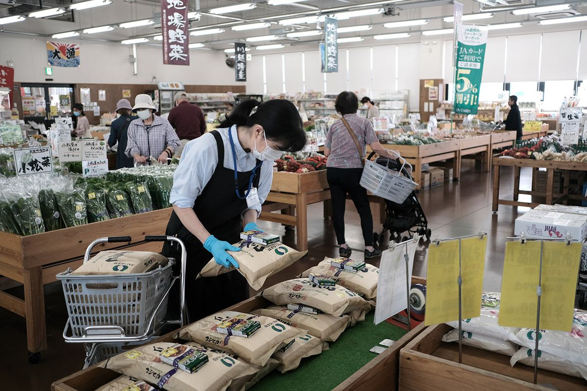 Rice Harvesting And Processing At JA Irumano Agricultural Cooperative A clerk displays bags of rice for sale at a grocery store operated by a JA Irumano Agricultural Cooperative in Kawagoe, Saitama Prefecture, Japan, on Wednesday, Sept. 30, 2020. Economists see prolonged weakness in business activity putting pressure on newly appointed Prime Minister Yoshihide Suga to provide more fiscal aid. Photographer: Soichiro Koriyama/Bloomberg via Getty Images