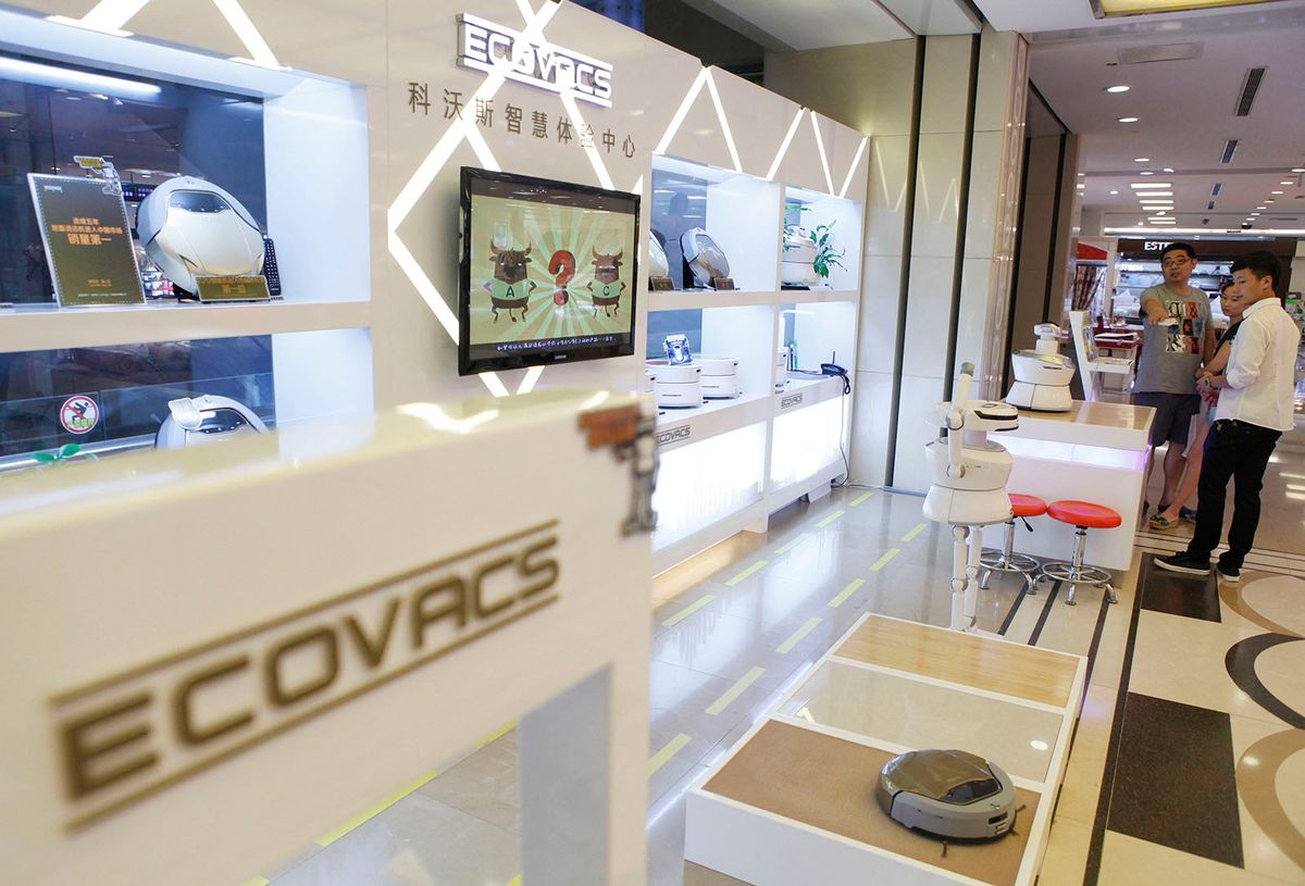 Chinese vacuum robot maker debuts on Shanghai Stock Exchange
--FILE--Customers shop for floor-cleaning robots at a store of Ecovacs Robotics in Wuhan city, central China's Hubei province, 24 July 2013.China's leading floor-cleaning robot maker Ecovacs Robotics listed on the Shanghai Stock Exchange Monday (28 May 2018). The company's share price rose by the upper debut limit of 44 percent to 28.83 yuan (4.51 U.S. dollars). Ecovacs earlier this month raised about 803 million yuan in an IPO by selling 40.1 million shares at 20.02 yuan each. The money will be mainly used to finance the development of a new plant capable of producing 4 million robots annually. (Photo by Jiu / Imaginechina / Imaginechina via AFP)
