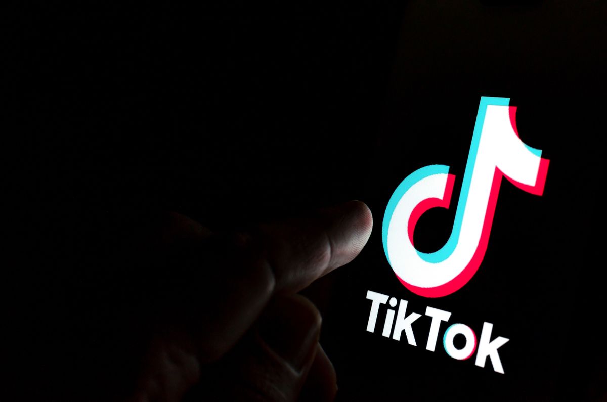 Tiktok,App,Logo,On,Screen,And,A,Finger,Pointing,At