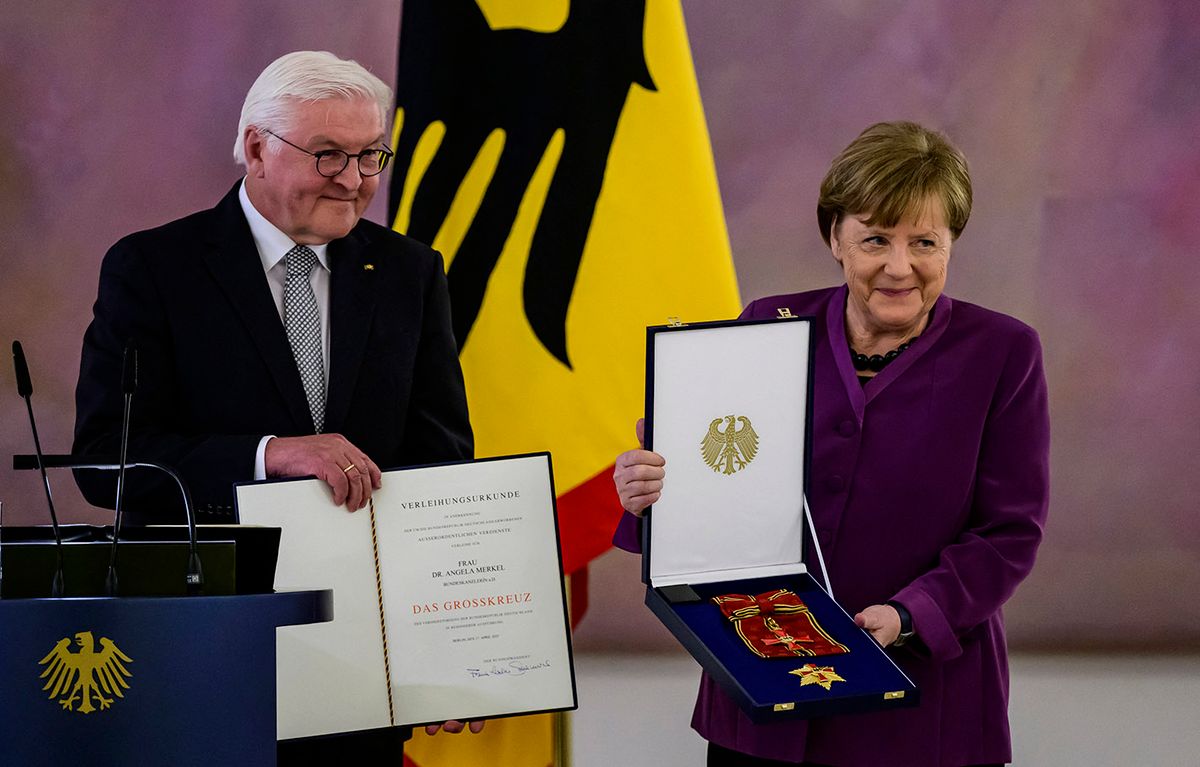 German President Frank-Walter Steinmeier (L) awards the Order of Merit to former German Chancellor Angela Merkel at the Bellevue presidential palace in Berlin on April 17, 2023. (Photo by John MACDOUGALL / AFP)