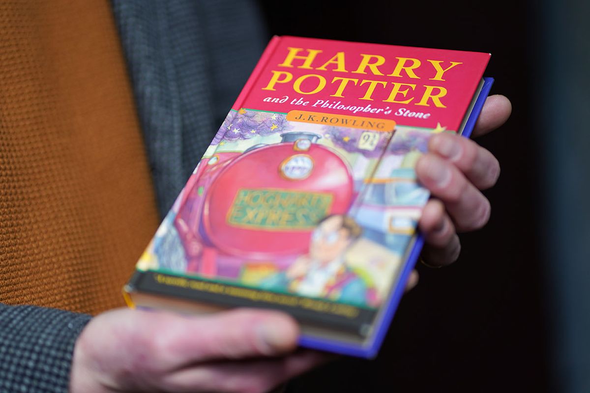 Harry Potter and the Philosopher's Stone first edition sale
1239002596
Auctioneer Jim Spencer holds a pristine first edition hardback of JK Rowling's Harry Potter and the Philosopher's Stone, one of only 500 produced in the first print run in 1997, on display at Hansons' Auctioneers at Bishton Hall, Staffordshire. The book has never been read and was kept in darkness for 25 years inside a protective sleeve and could fetch up to £100,000 when it goes under the hammer at Hanson's Library Auction on March 9. Picture date: Monday March 7, 2022. (Photo by Jacob King/PA Images via Getty Images)