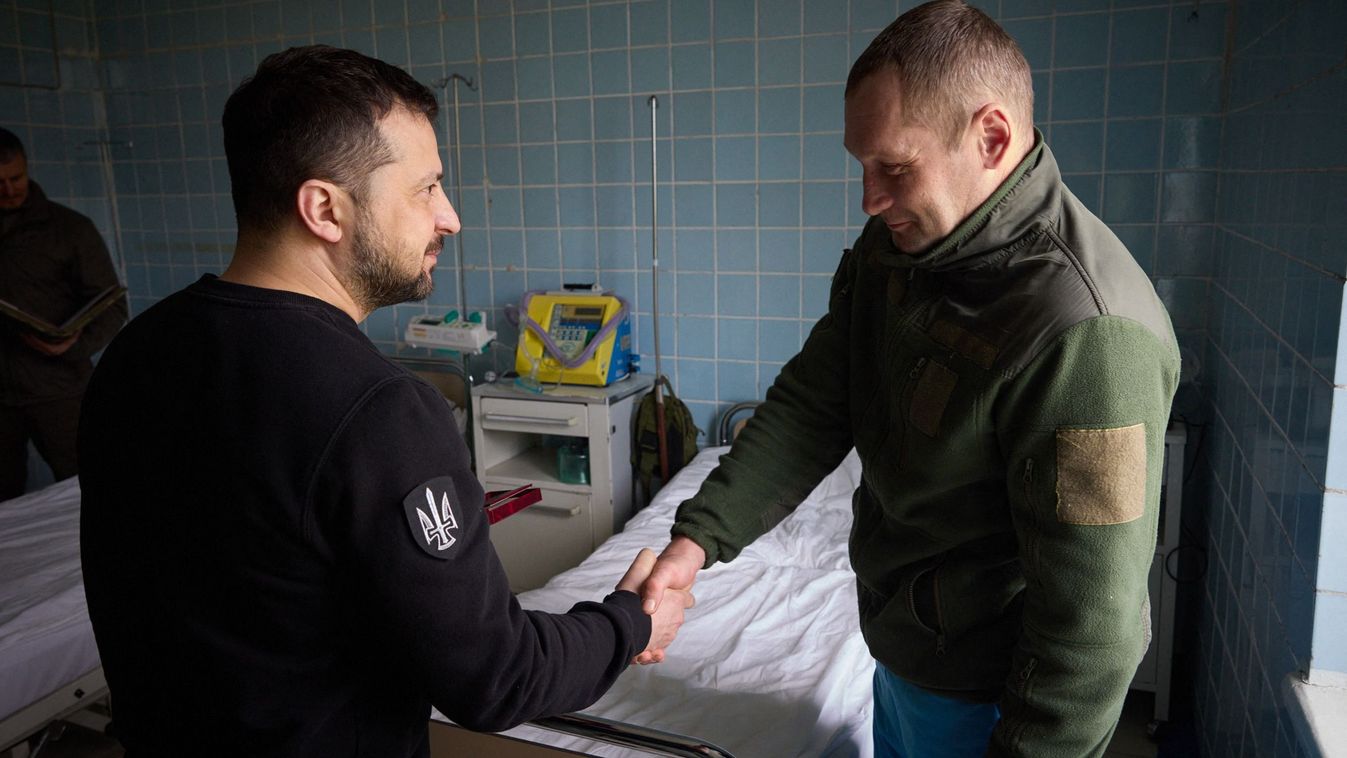 This handout picture taken and released by Ukrainian presidential press service on April 18, 2023 shows Ukrainian president Volodymyr Zelensky (L) awarding a wounded serviceman at the military hospital of the heavily shelled frontline in the Donetsk region, amid Russian invasion of Ukraine.