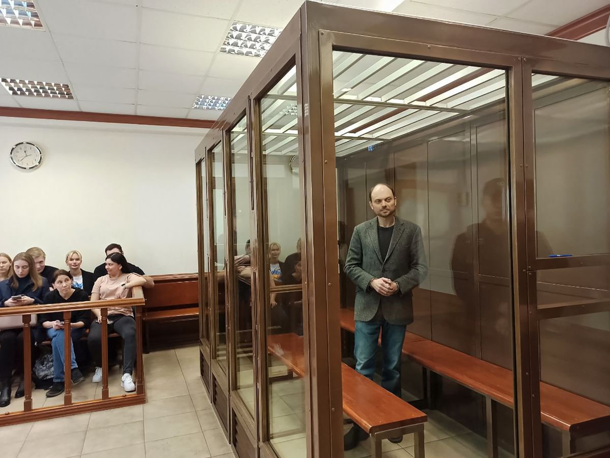 Russian opposition figure Vladimir Kara-Murza, who is accused of treason and spreading "false" information about the Russian army, stands inside a defendants' cage during his sentencing at the Moscow City Court in Moscow on April 17, 2023.