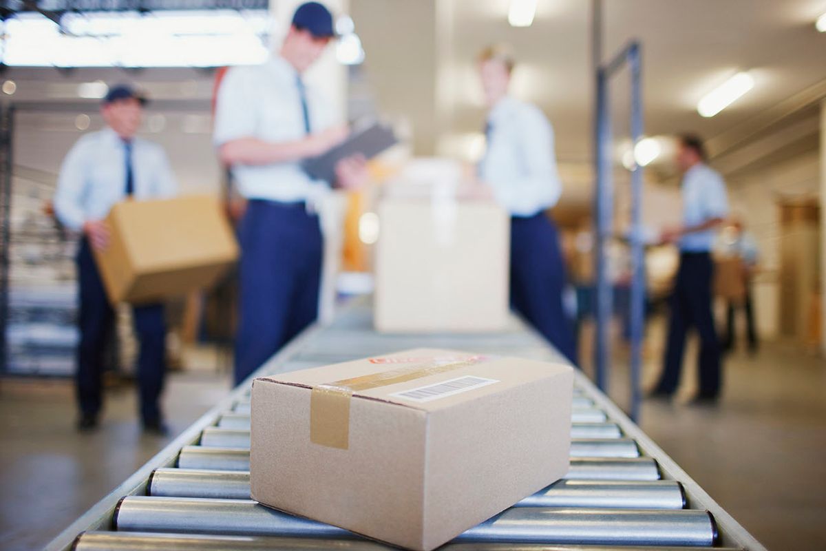 Box on conveyor belt in shipping area
