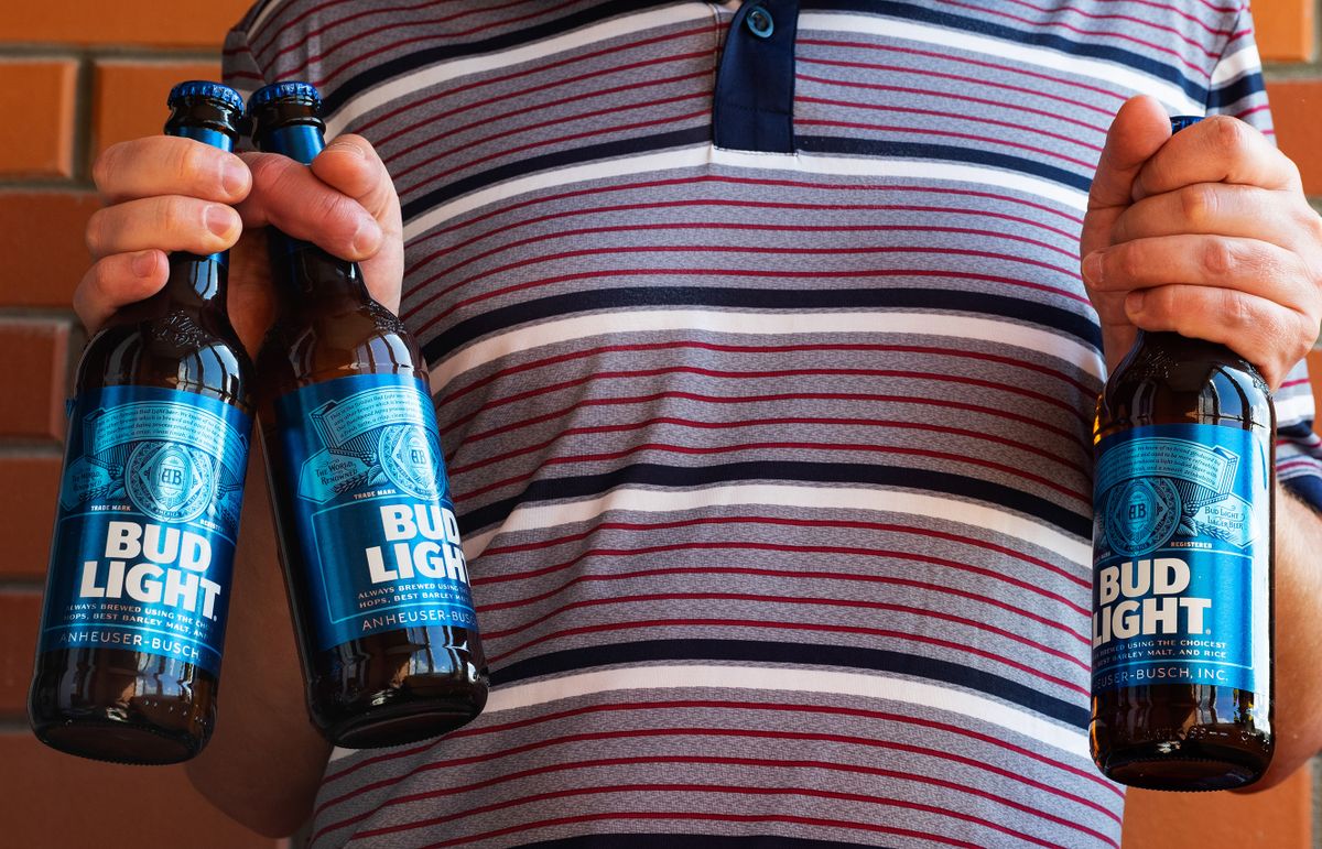 In this photo illustration, a man holds Bud Light beer