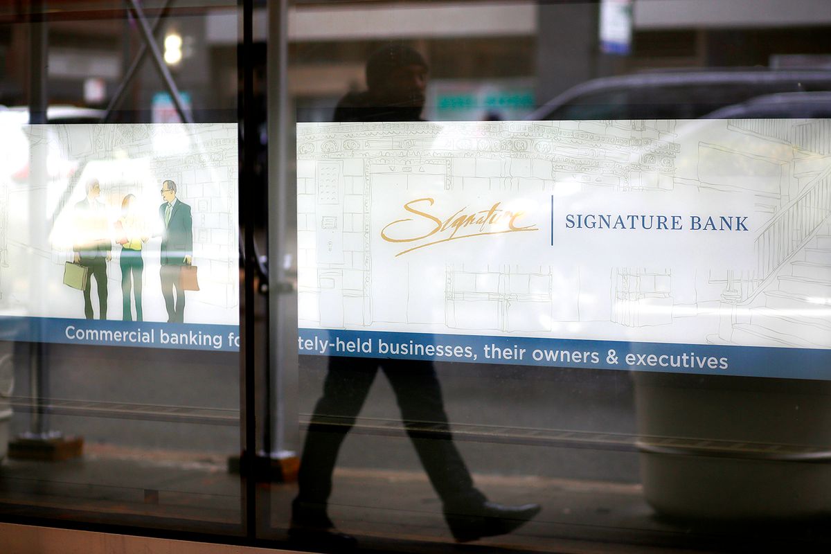 Signature Bank Closed by Regulators
NEW YORK, NEW YORK - MARCH 13: A man is reflected at the Signature Bank branch window on March 13, 2023 in New York City. Signature Bank a $110 billion commercial bank with offices in California, Connecticut, Nevada, New York and North Carolina, was closed by Regulators on Sunday the customers alarmed by SVB yanked their funds. (Photo by Leonardo Munoz/VIEWpress)
