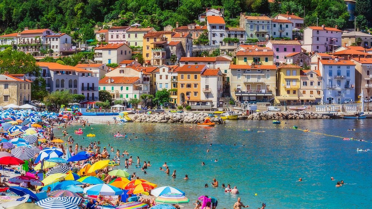 People enjoying at beach by Opatija town during summer