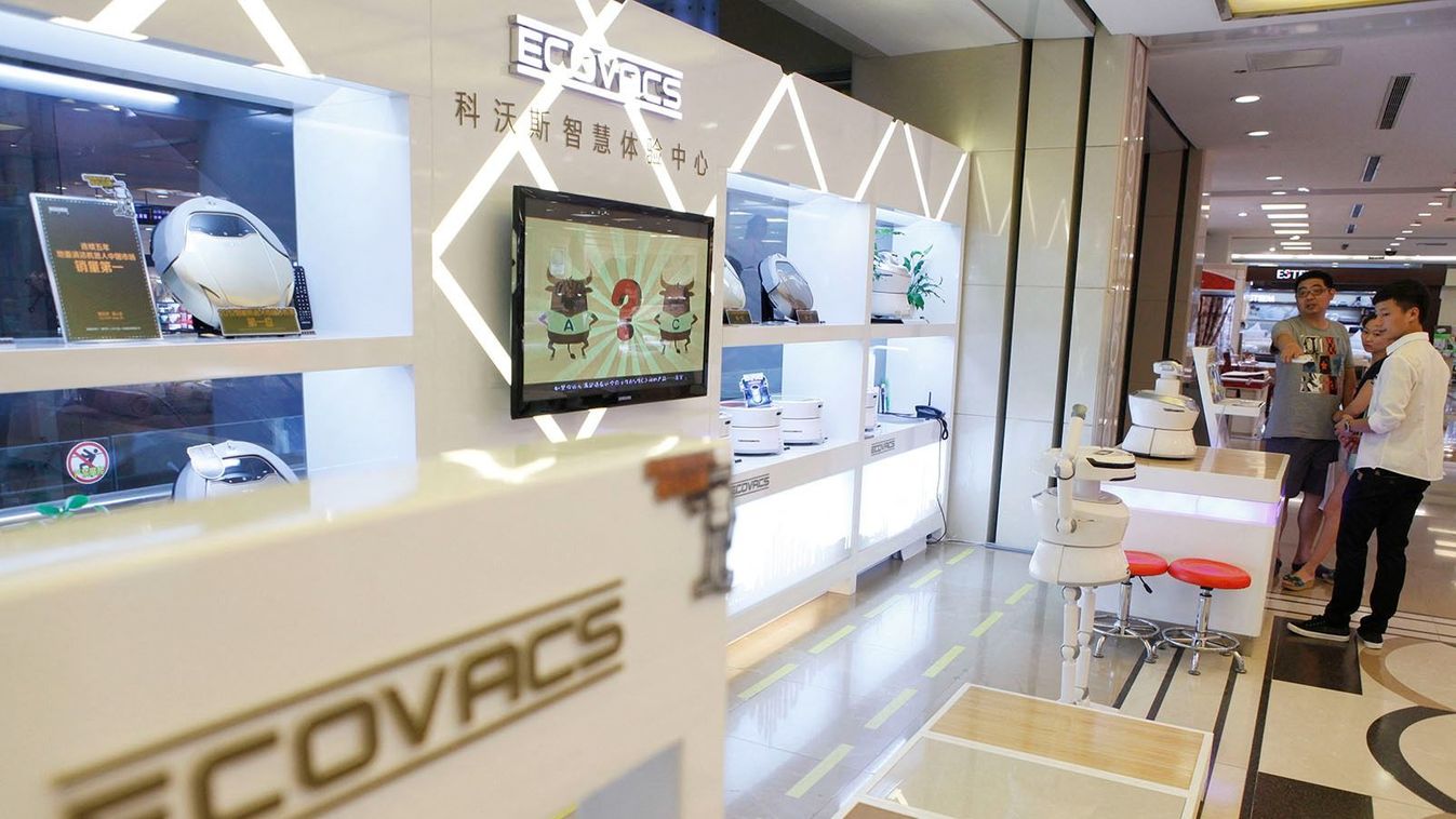 Chinese vacuum robot maker debuts on Shanghai Stock Exchange
--FILE--Customers shop for floor-cleaning robots at a store of Ecovacs Robotics in Wuhan city, central China's Hubei province, 24 July 2013.China's leading floor-cleaning robot maker Ecovacs Robotics listed on the Shanghai Stock Exchange Monday (28 May 2018). The company's share price rose by the upper debut limit of 44 percent to 28.83 yuan (4.51 U.S. dollars). Ecovacs earlier this month raised about 803 million yuan in an IPO by selling 40.1 million shares at 20.02 yuan each. The money will be mainly used to finance the development of a new plant capable of producing 4 million robots annually. (Photo by Jiu / Imaginechina / Imaginechina via AFP)