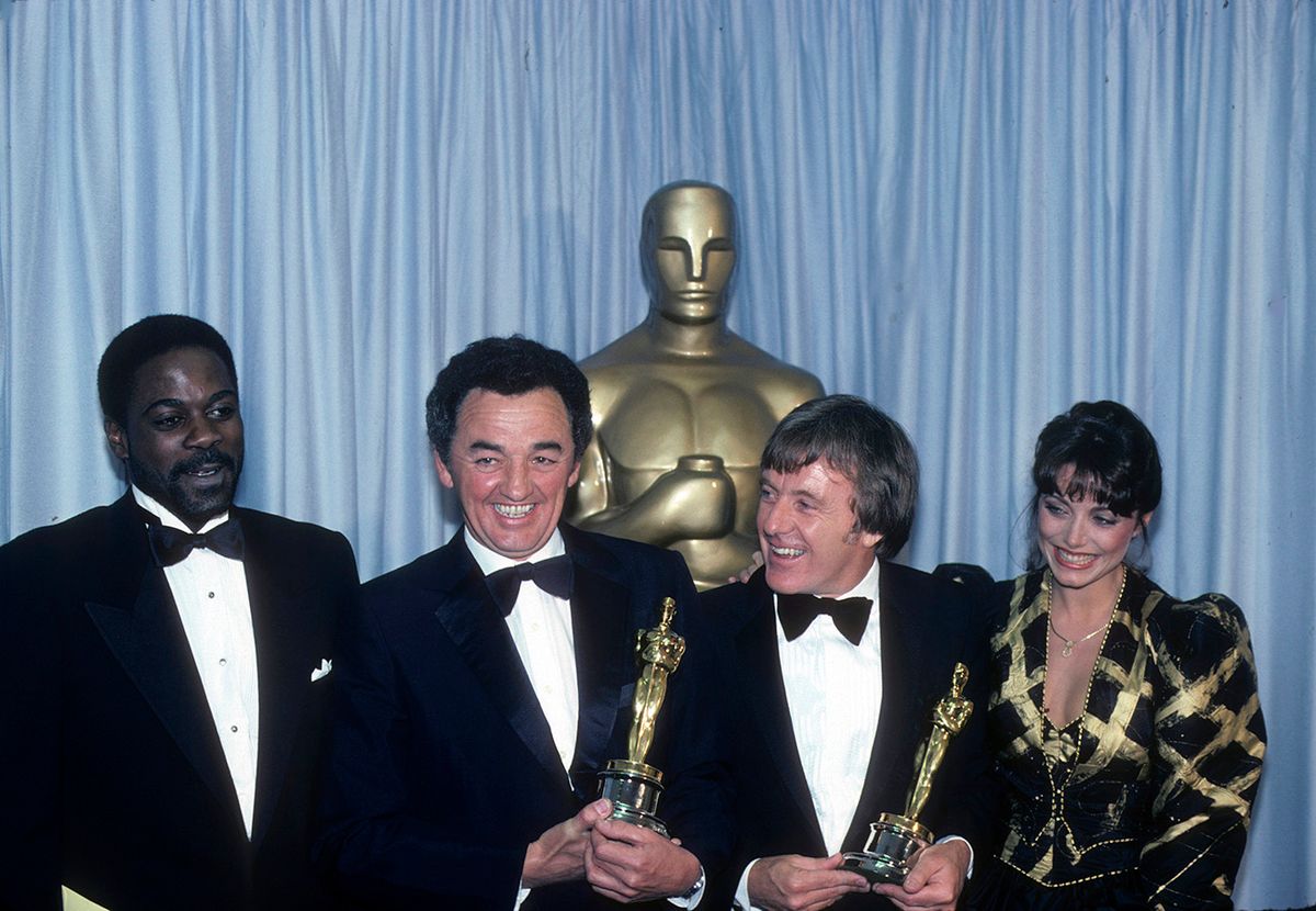 HOWARD E. ROLLINS, JR.;
NORMAN REYNOLDS;
MICHAEL FORD;
KAREN ALLEN

THE 54TH ANNUAL ACADEMY AWARDS - Backstage Coverage - Airdate: March 29, 1982. (Photo by ABC Photo Archives/Disney General Entertainment Content via Getty Images)NORMAN REYNOLDS (C, L) AND MICHAEL FORD (C, R), BEST ART DIRECTION WINNERS FOR "RAIDERS OF THE LOST ARK" WITH PRESENTERS HOWARD E. ROLLINS, JR. AND KAREN ALLEN