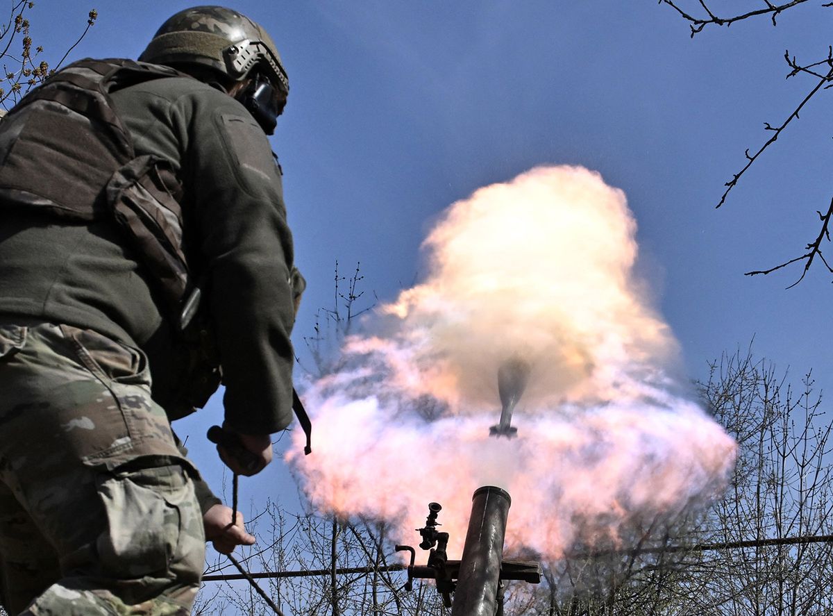 A Belarusian volunteer soldier from the Kastus Kalinouski regiment, a regiment made up of Belarusian opposition volunteers formed to defend Ukraine, fires a 120mm mortar round at a front line position near Bakhmut in the Donetsk region, on April 9, 2023, amid the Russian invasion of Ukraine. (Photo by Genya SAVILOV / AFP)
UKRAINE-RUSSIA-CONFLICT-WAR