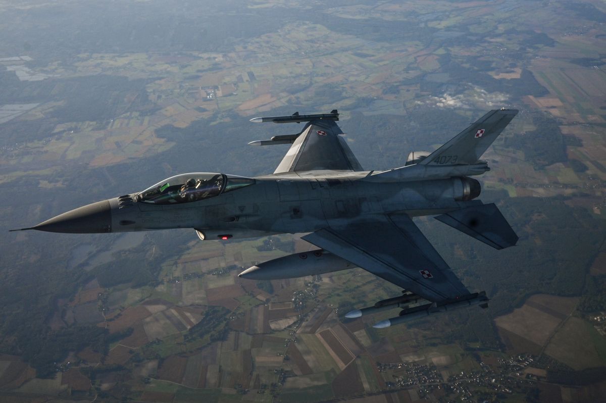 LASK, POLAND - OCTOBER 12: F-16 Fighting Falcon from the Polish Air Force takes part in a NATO air Shielding exercise at the  Lask Air Base on October 12, 2022 in Lask, Poland. NATO's Allied Air Command, the Polish Air Force and the United States Air Force demonstrate the modern aircraft capabilities of Polish F-16s and the U.S. F-22s. As the Russian Invasion of Ukraine continues, NATO member Poland has been investing in new military equipment and various NATO allies' troops are now stationed in the country. 