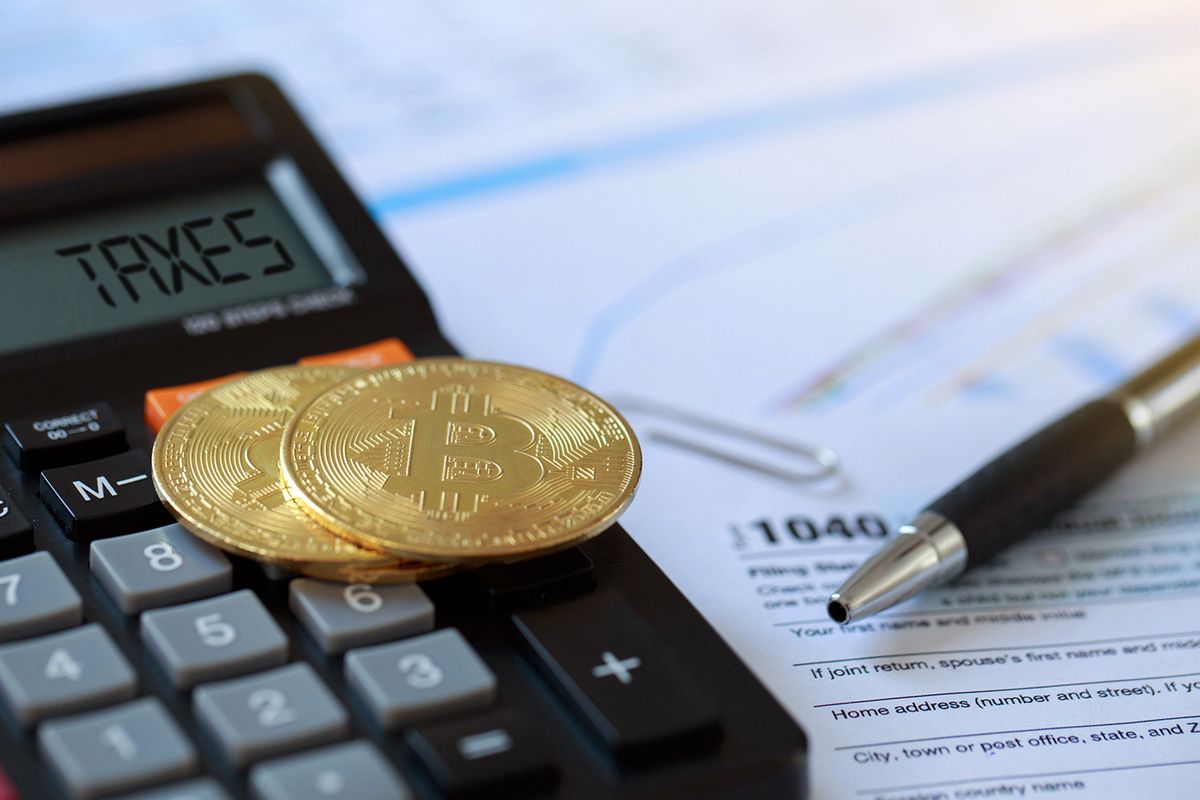 Bitcoin,On,A,Calculator,And,Individual,Income,Tax,Return,Form
Bitcoin on a calculator and individual income tax return form 1040. tax for the trading of crypto-currencies.The time to pay taxes concept.