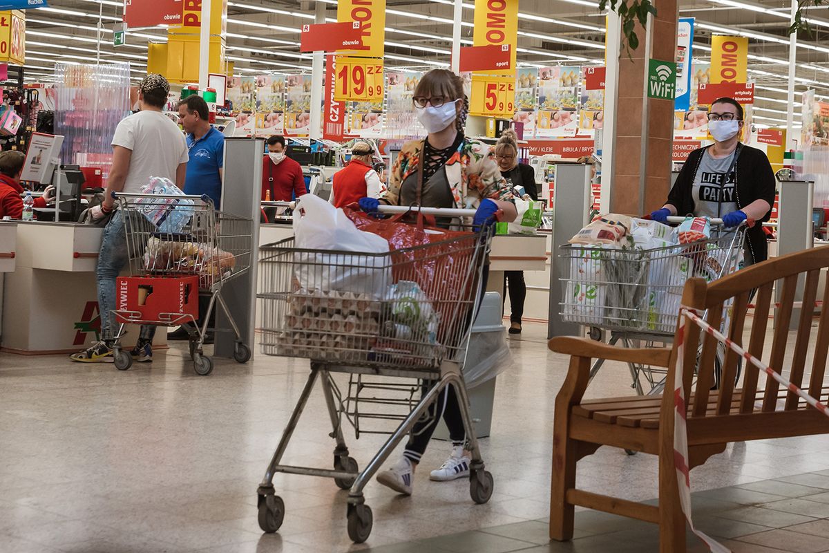 Lubin,,Poland,-,April,9,,2020.,Women,Customers,With,Face
LUBIN, POLAND - APRIL 9, 2020. Women customers with face mask and trolleyes after shopping in Auchan supermarket.