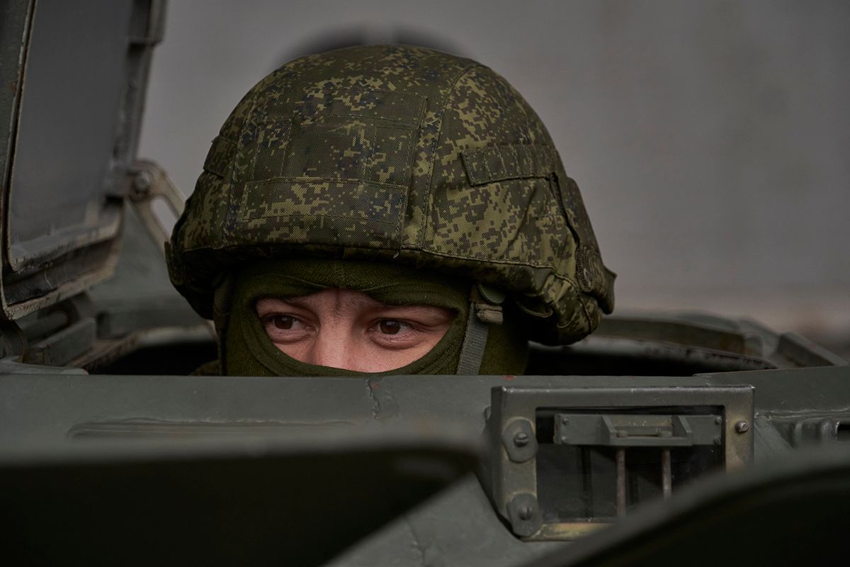 A Russian serviceman keeps watch from the hatch of a military vehicle as the delegation of the International Atomic Energy Agency (IAEA), including its head Rafael Grossi, visits the Russian-controlled Zaporizhzhia nuclear power plant in southern Ukraine on March 29, 2023. (Photo by Andrey BORODULIN / AFP)
UKRAINE-RUSSIA-CONFLICT