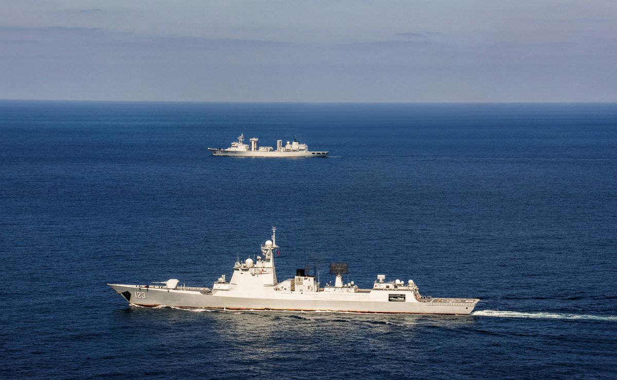 (230331) -- QINGDAO, March 31, 2023 (Xinhua) -- The missile destroyer Huainan (down) and the supply ship Hoh Xil (up) of the 42nd fleet of the Chinese People's Liberation Army Navy sail on the sea, on Feb. 3, 2023. A Chinese naval fleet returned to east China's port city of Qingdao in Shandong Province on Thursday after completing its mission of escorting civilian vessels in the Gulf of Aden and in the waters off Somalia. 