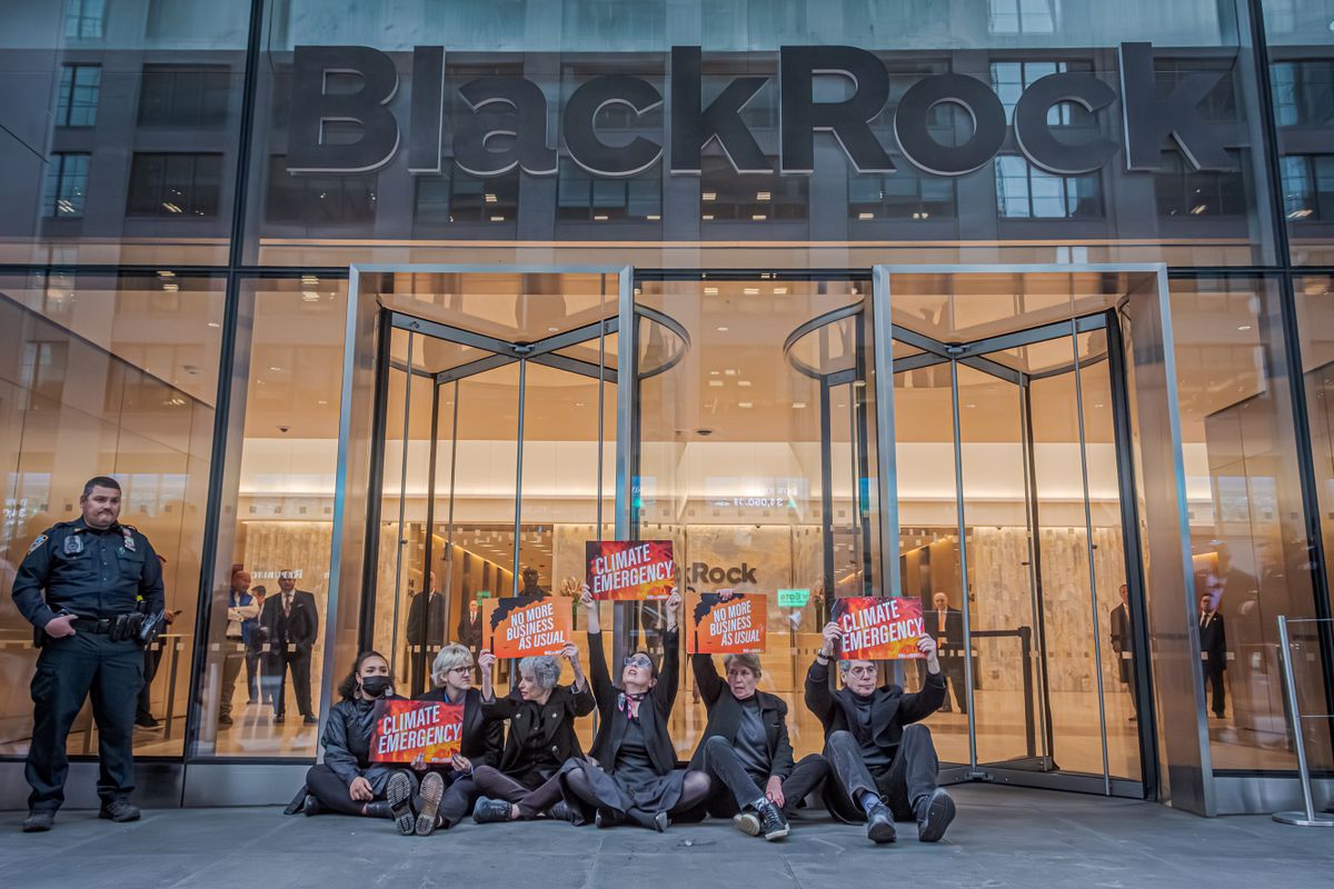 MANHATTAN, NEW YORK, UNITED STATES - 2023/04/28: Participants seen holding signs at the protest outside BlackRock headquarters. Eleven Climate Activists  were arrested after storming the barricades and pouring fake oil at BlackRock's headquarters in Manhattan. Along with 75 other activists with pitchforks, they shut down the HQ entrance to demand that the company - the world's largest investor in fossil fuels - end new investments in coal, oil and gas, in line with the basic scientific requirements of avoiding global climate catastrophe. 