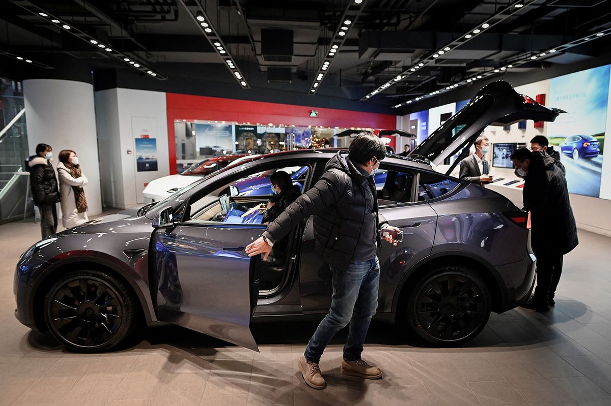 CHINA-AUTO
People look at a Tesla Model Y car at a Tesla showroom in Beijing on January 5, 2021. (Photo by WANG Zhao / AFP)