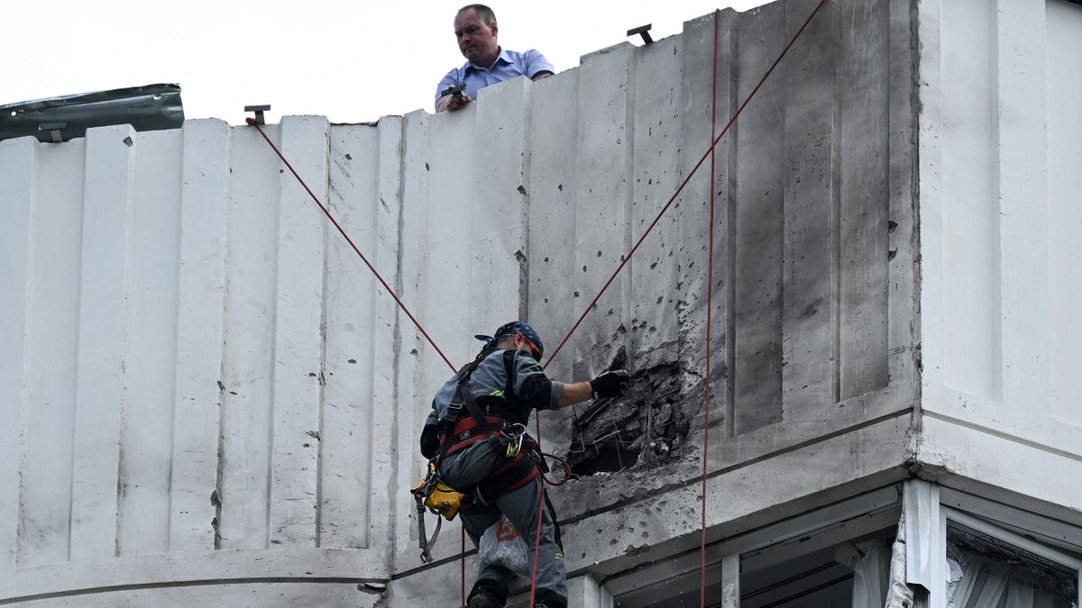 A specialist inspects the damaged facade of a multi-storey apartment building after a reported drone attack in Moscow on May 30, 2023. 