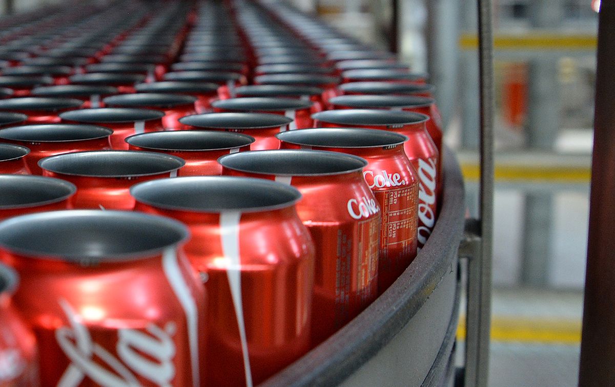 Production Inside A Coca-Cola Amatil Ltd. Plant
Empty Coca-Cola Classic cans move along a conveyor to be filled and sealed at a Coca-Cola Amatil Ltd. production facility in Melbourne, Australia, on Tuesday, Aug. 19, 2014. Coca-Cola Amatil flagged a second consecutive drop in full-year earnings amid weak consumer confidence and rising costs in Indonesia. Photographer: Carla Gottgens/Bloomberg via Getty Images