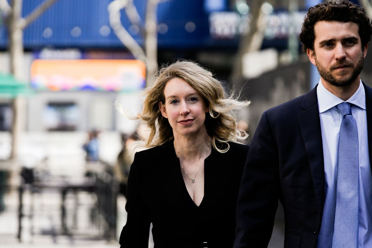 SAN JOSE, CA - MARCH 17: Former Theranos CEO Elizabeth Holmes alongside her boyfriend Billy Evans, walks back to her hotel following a hearing at the Robert E. Peckham U.S. Courthouse on March 17, 2023 in San Jose, California. Holmes appeared in court for a restitution hearing. 