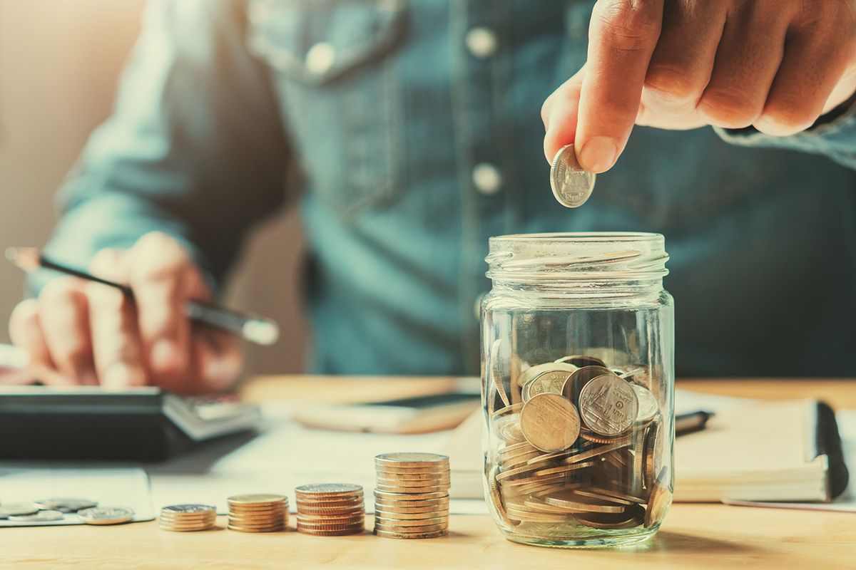 Businessman,Holding,Coins,Putting,In,Glass.,Concept,Saving,Money,For