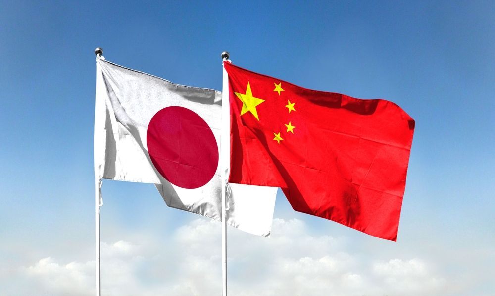 Chinese,Flag,And,Japanese,Flag,With,Blue,Sky.,Waving,Blue