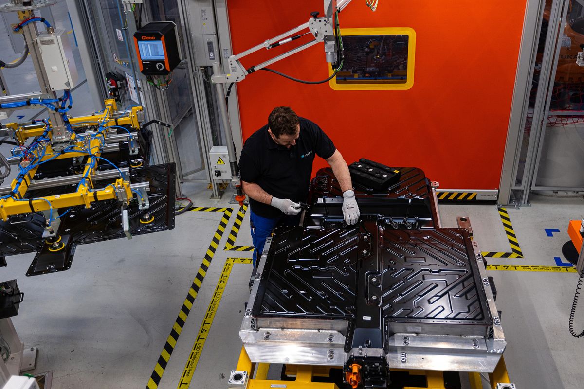 An employee fixes the upper housing to the cell block and lower housing section of an electric vehicle battery at an Accumotive GmbH plant, a subsidiary of Mercedes-Benz AG, in Kamenz, Germany, on Wednesday, March 22, 2023. Mercedes is trying to focus on its top-end vehicles such as the S-Class sedan to bolster profits and help fund its multi-billion-euro shift to electric vehicles. 