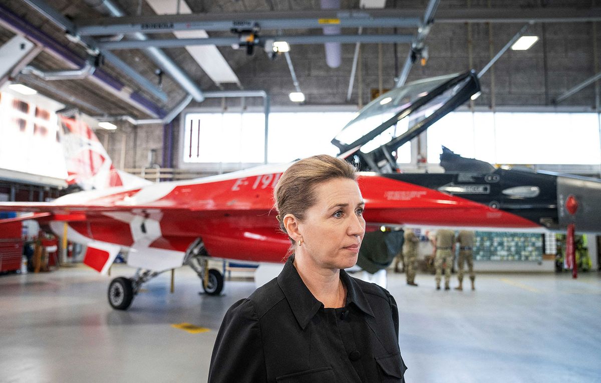 Mette FrederiksenDENMARK-US-UKRAINE-CONFLICT-MILITARY-DEFENCEDanish Prime Minister Mette Frederiksen stands in front of an F-16 fighter jet in the colours of the Danish flag Dannebrog - red and white - as she visits the Fighter Wing Skrydstrup Air Base near Vojens, Denmark on May 25, 2023. US President Joe Biden will host Danish Prime Minister Mette Frederiksen for talks on June 5, the White House said May 23, as the Scandinavian country mulls providing fighter jets for Ukraine. NATO member Denmark is part of an international coalition set up recently to provide fighter jets to the Ukrainian army, including US-made F-16 aircraft, as Kyiv prepares for a major counteroffensive against Russian forces. Denmark is in the process of replacing its F-16 fleet with F-35 planes and has already committed to training Ukrainian pilots. But Copenhagen has not yet indicated whether it will be among those countries that will deliver the jets. (Photo by Bo Amstrup / Ritzau Scanpix / AFP) / Denmark OUT
