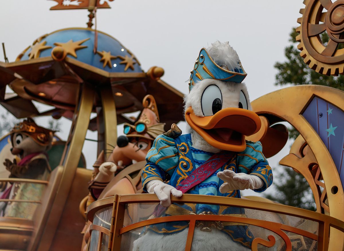 Marne-la-Vallée, France - 10 13 2022 : Close up of a costumed actor of DOnald Duck in a float during a parade in Disneyland Paris park.