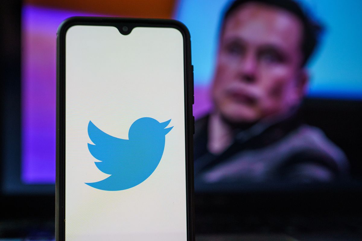 Kaunas, Lithuania 2022 April 5: Twitter logo on smartphone and Elon Musk in the background. Elon Musk joins Twitter board
