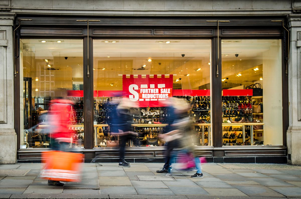 Motion,Blurred,Shoppers,Walking,Past,Window,Display