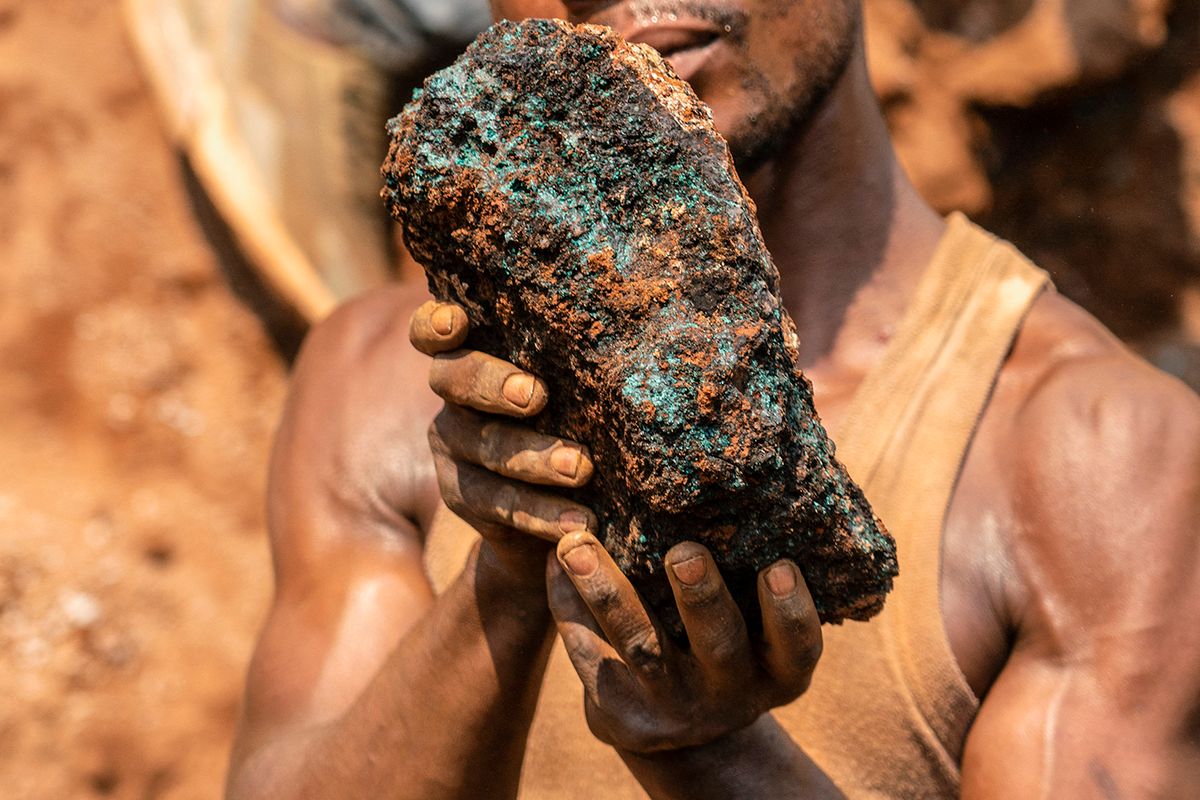 DRCONGO-ECONOMY-MINING
Dela wa Monga, an artisanal miner, holds a cobalt stone at the Shabara artisanal mine near Kolwezi on October 12, 2022. - Some 20,000 people work at Shabara, in shifts of 5,000 at a time.Congo produced 72 percent of the world’s cobalt last year, according to Darton Commodities. And demand for the metal is exploding due to its use in the rechargeable batteries that power mobile phones and electric cars.But the country’s poorly regulated artisanal mines, which produce a small but not-negligeable percentage of its total output, have tarnished the image of Congolese cobalt. (Photo by Junior KANNAH / AFP)