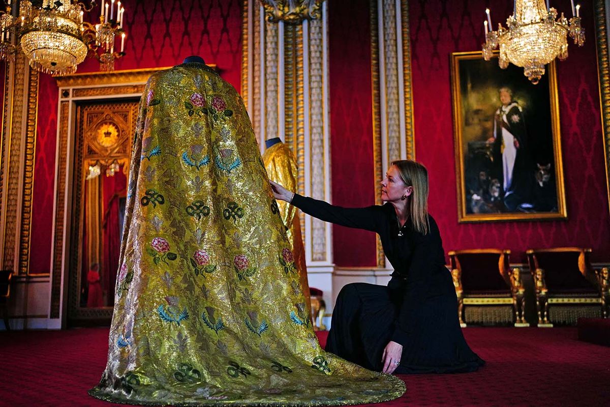 King Charles III coronation
BRITAIN-ROYALS-CORONATION-KING-PREPARATIONS
EMBARGOED TO 2200 BST MONDAY MAY 1Caroline de Guitaut, deputy surveyor of the King's Works of Art for the Royal Collection Trust, adjusts the Imperial Mantle, which forms part of the Coronation Vestments in the Throne Room at Buckingham Palace in London on April 26, 2023. - The vestments will be worn by Britain's King Charles III during his coronation at Westminster Abbey on May 6. (Photo by Victoria Jones / POOL / AFP)