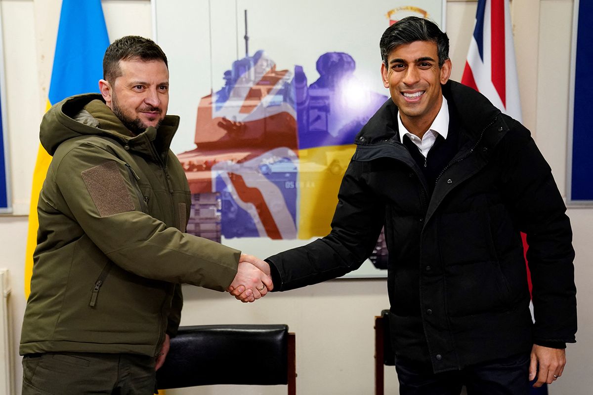 BRITAIN-UKRAINE-RUSSIA-CONFLICT-DIPLOMACY
Ukraine's President Volodymyr Zelensky (L) and Britain's Prime Minister Rishi Sunak shake hands after signing a declaration of unity at a military facility at a military facility in Lulworth, Dorset in southern England on February 8, 2023. Zelensky used a visit to London to urge allies to send combat aircraft to his war-torn country, which Britain said it would consider in the "long term". (Photo by Andrew Matthews / POOL / AFP)