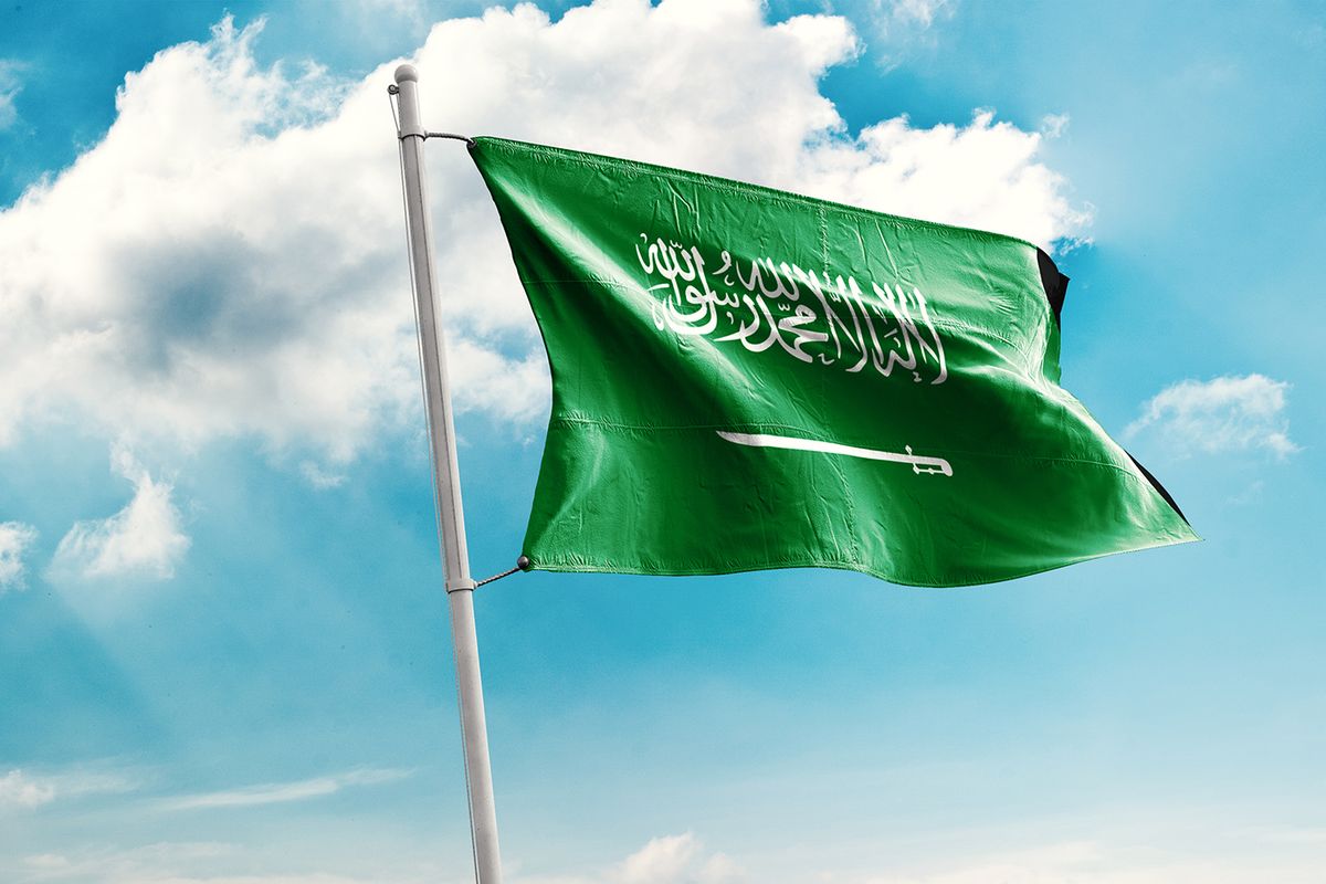 Waving Flag of Saudi Arabiain Blue Sky. Saudi ArabiaFlag on pole for Independence day. The symbol of the state on wavy cotton fabric.