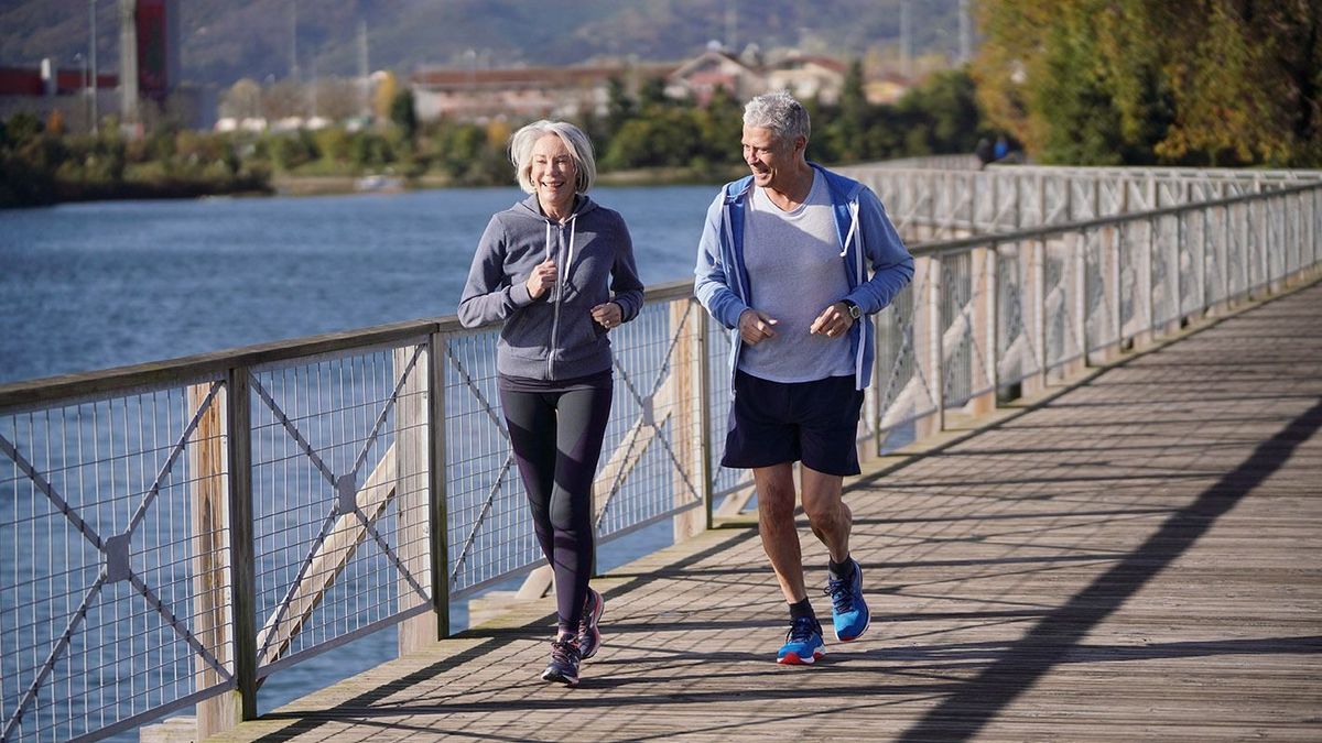 Active,Senior,Couple,Jogging,Together,On,Bridge