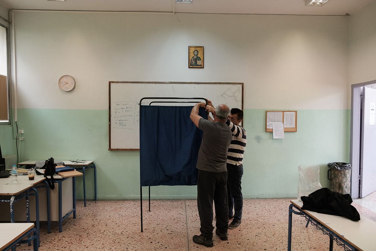 Municipality workers assemble a polling booth in a school classroom for the upcoming parliamentary elections of May 21, in Thessaloniki, Greece on May 19, 2023. (Photo by Thomas Giotopoulos / SOOC / SOOC via AFP)
