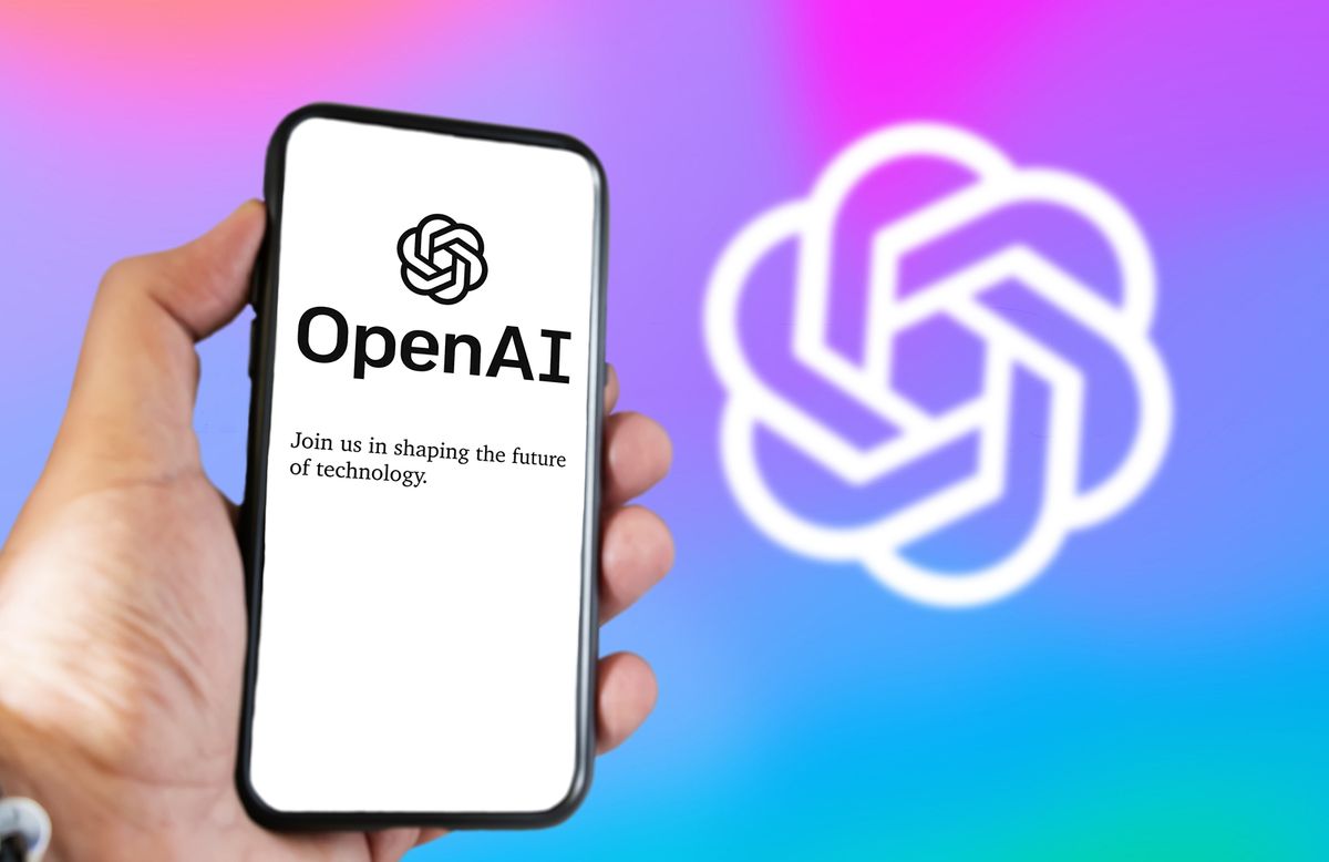 San,Francisco,Us,,Dec,2022:,A,Hand,Holding,A,Phone San Francisco US, Dec 2022: A hand holding a phone with the OpenAI website on the screen. Colorful background with blurred logo. OpenAI is a non-profit artificial intelligence research organization.