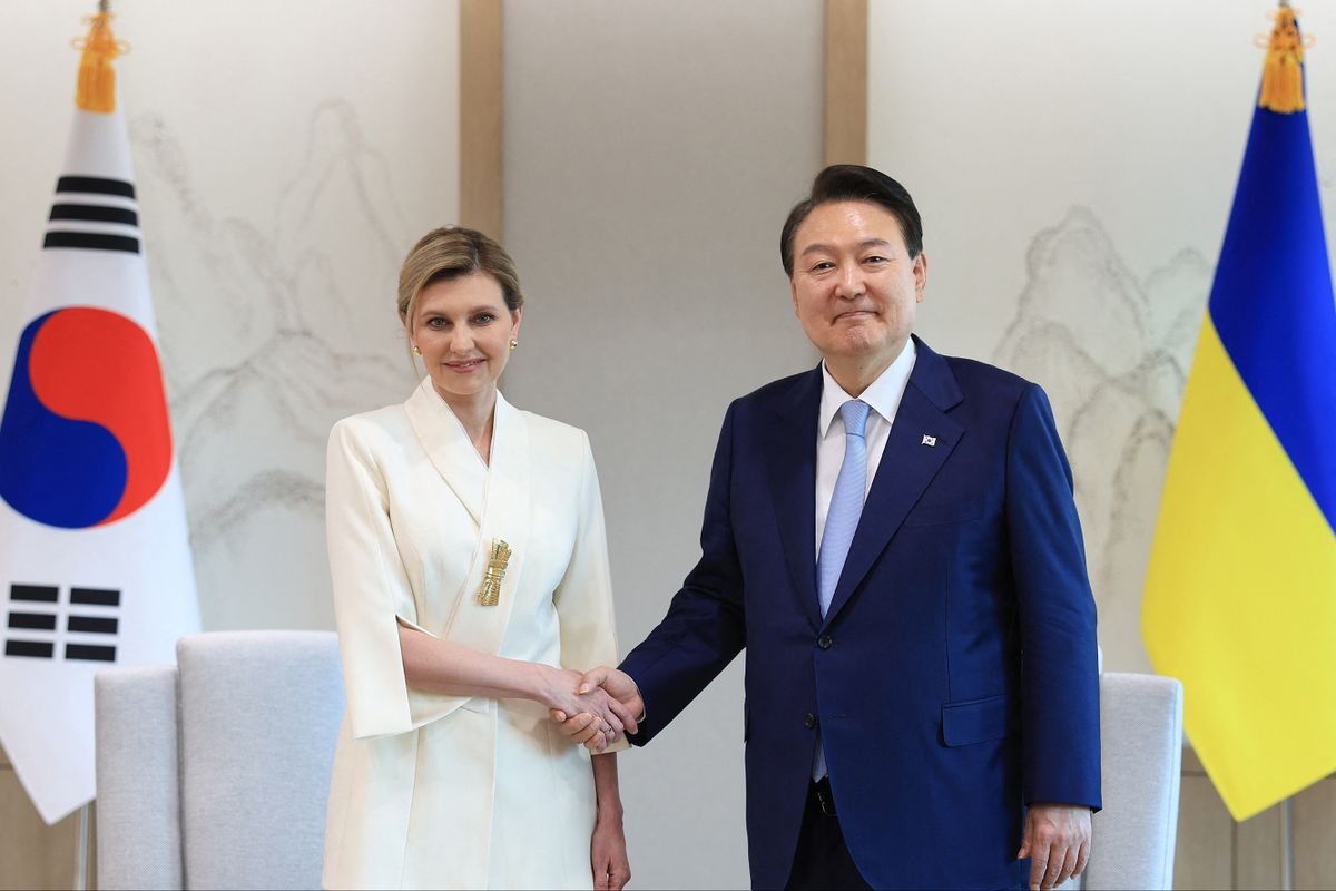 This handout photo taken on May 16, 2023 and released by the South Korean Presidential Office via Yonhap shows South Korean President Yoon Suk Yeol (R) shaking hands with Ukraine's First Lady Olena Zelenska (L) at the presidential office in Seoul. 