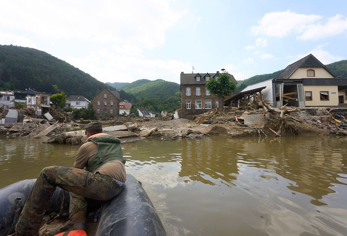 After the storm in RhineAfter the storm in Rhineland-Palatinateland-Palatinate20 July 2021, Rhineland-Palatinate, Rech: The Ahr valley bridge in Rech is totally destroyed by the flood. At the moment you can only cross the river Ahr with the inflatable boat of the Bundeswehr. A temporary bridge is under construction. Photo: Thomas Frey/dpa (Photo by THOMAS FREY / DPA / dpa Picture-Alliance via AFP)