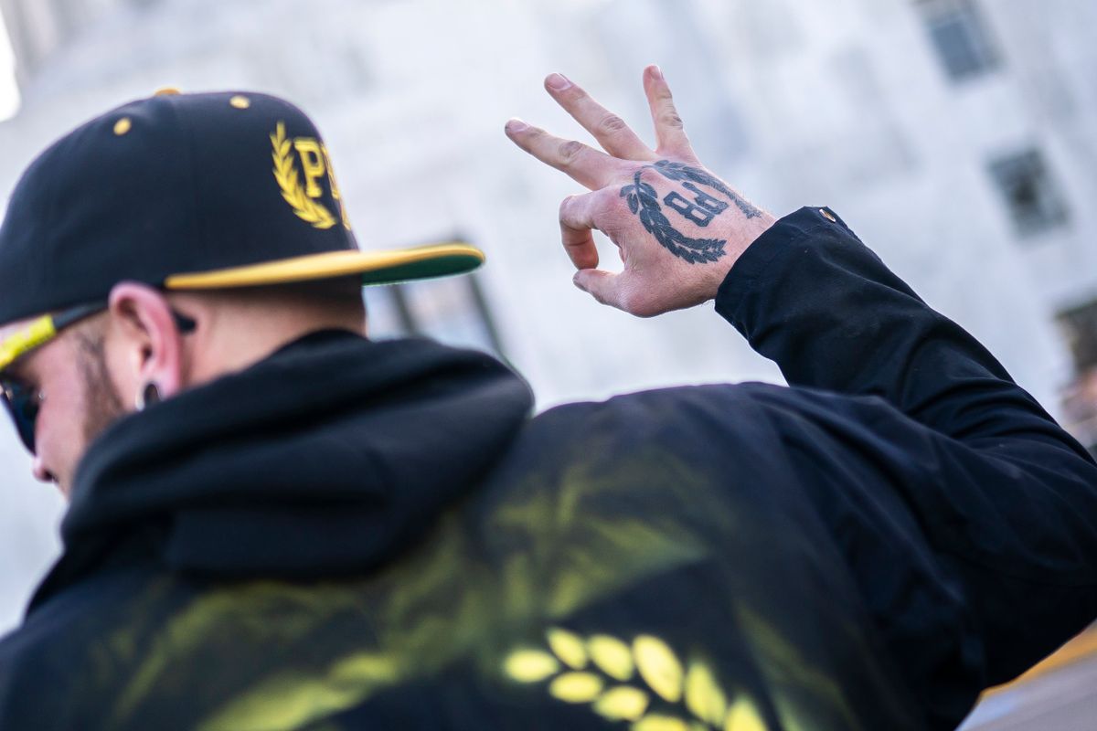 SALEM, OR - JANUARY 08: A Proud Boys gestures in front of the Oregon state capitol during a protest in support of the January 6 attack on the U.S. Capitol on January 8, 2022 in Salem, Oregon. The Proud Boy organization in Oregon has long been supportive of those arrested in last January's riot in Washington D.C. 