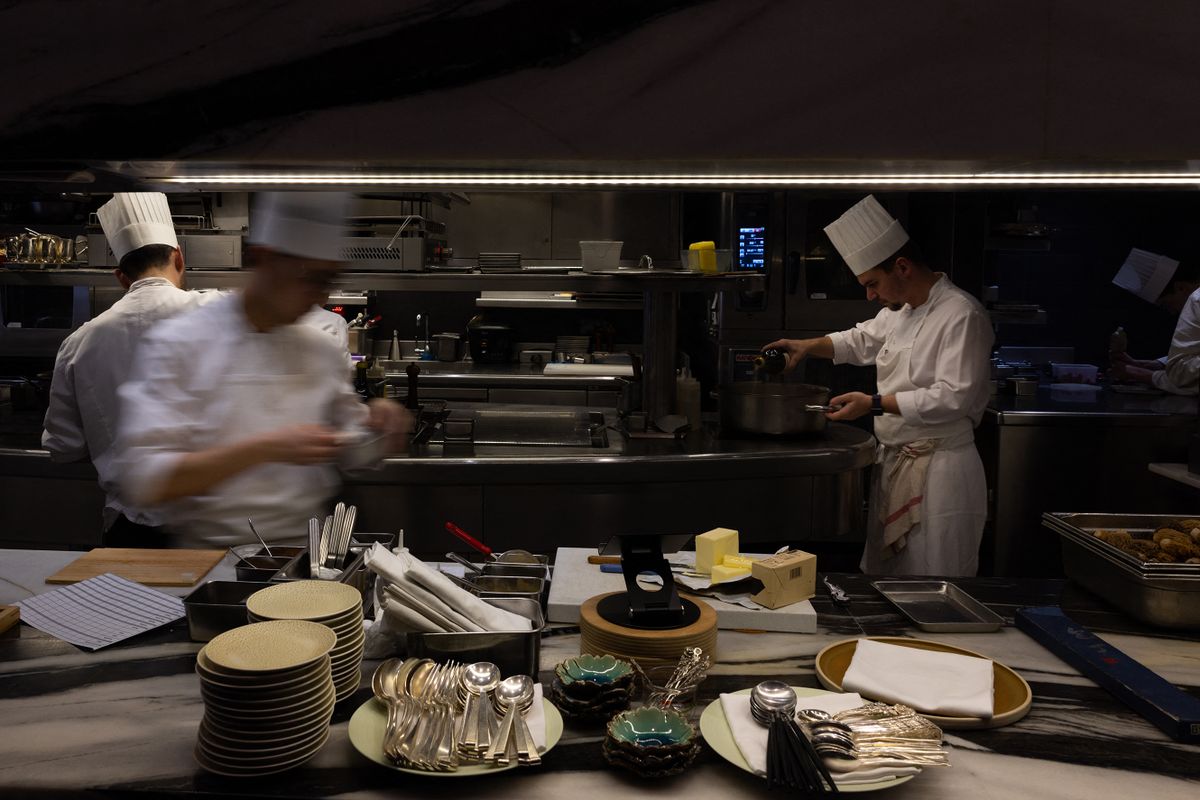Cooks work at "Le Grand Restaurant" in Paris on May 4, 2023. 