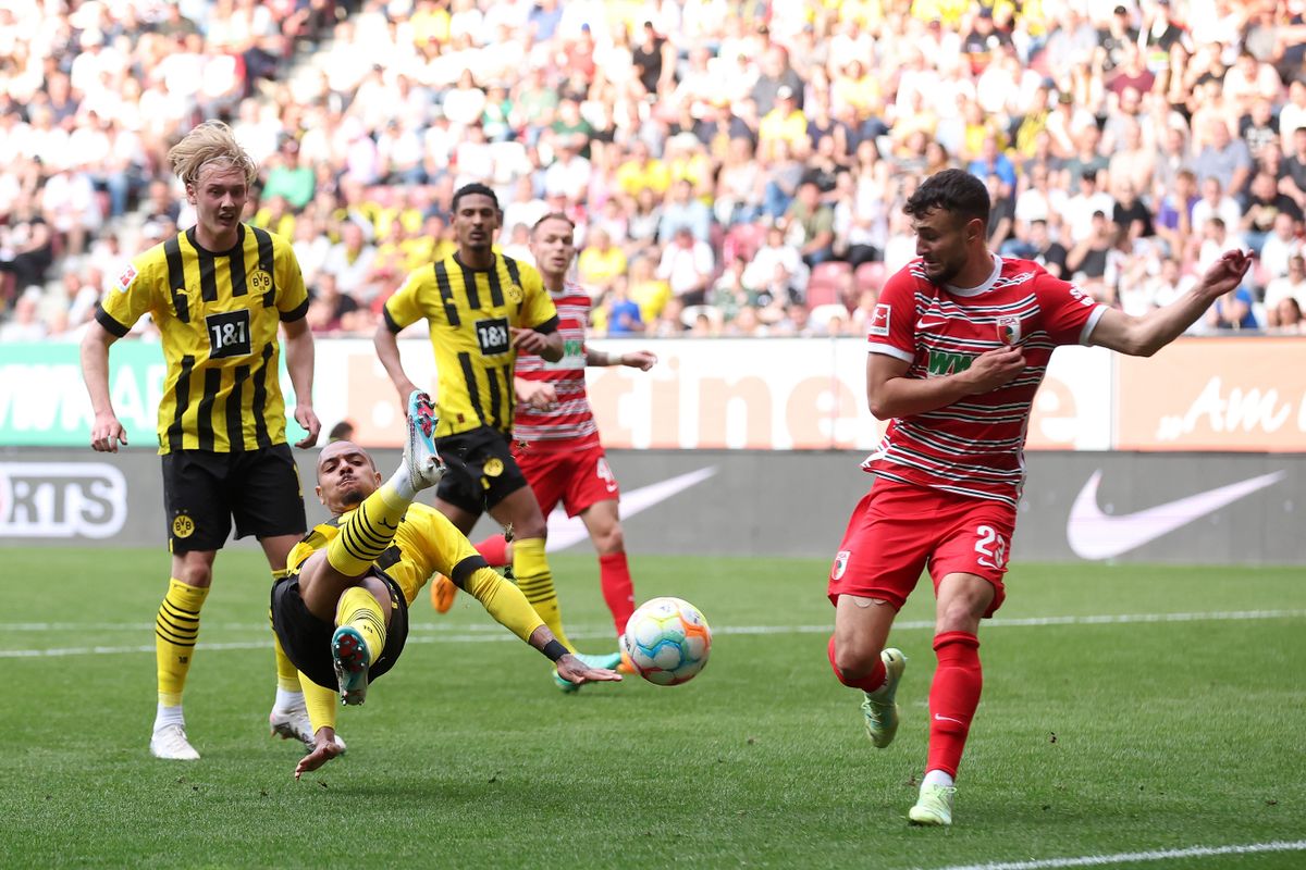 AUGSBURG, GERMANY - MAY 21: Donyell Malen of Borussia Dortmund shoots but misses during the Bundesliga match between FC Augsburg and Borussia Dortmund at WWK-Arena on May 21, 2023 in Augsburg, Germany.