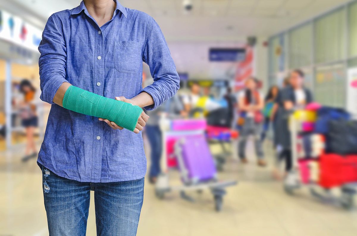 Injured,Woman,With,Green,Cast,On,Hand,And,Arm,On